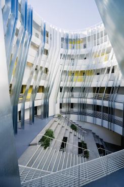 All of the building's 95 residential units open onto a circular central courtyard. Bent galvanized metal fins stretch up to the roof, and a set of concrete stairs has seating-height risers, allowing the space to be used for casual gatherings or community meetings.