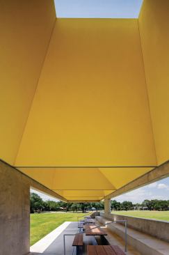  Inside the pavilion, four voids—each framed in exterior cement board and coated with a fine-grained plaster that is painted a vivid yellow—draw out hot air, cooling the seating 

area below.