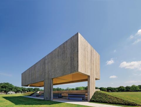 The canopy provides shade for benches and tables made with Ipe wood seats on painted-steel supports. The terraced concrete seating is nestled into an earthen berm that absorbs heat and helps choreograph views.