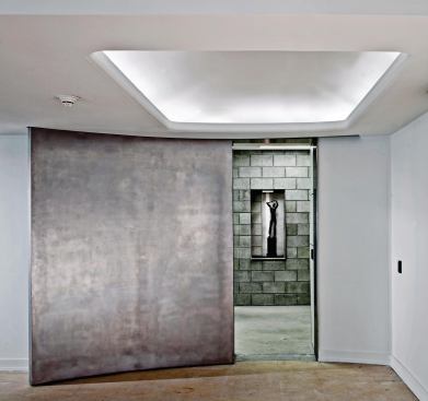 At the east end of a ground-level gallery, a sliding metal door opens into the cool, cellarlike confines of the new Collections Wing.