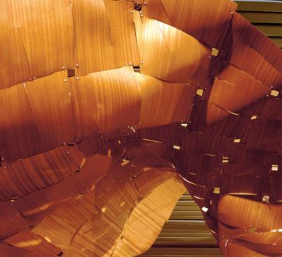 The "Immaterial/Ultramaterial" installation of thin-ply panels by Nader Tehrani's students at Harvard explored the link between architecture and textiles. Techniques such as pleating, darting, and tabbing were used to create structural rigidity.