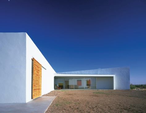 The 2,600-square-foot Mound House, completed in 2002 in Marfa, Texas, was designed with traditional adobe bricks and steel spanning frames. The main living spaces open onto a V-shaped courtyard. 