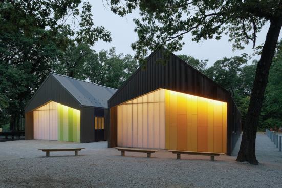 Lit sheds at dusk.