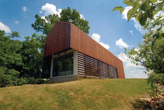 The Sustainable Residence's southern exposure facilitates passive solar. Active systems, such as photovoltaic panels and a wind turbine, also contribute to the project's sustainability.