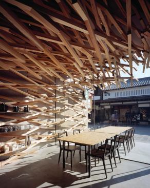 Seating and store display areas at the front of the Starbucks store look out onto the neighboring shops.