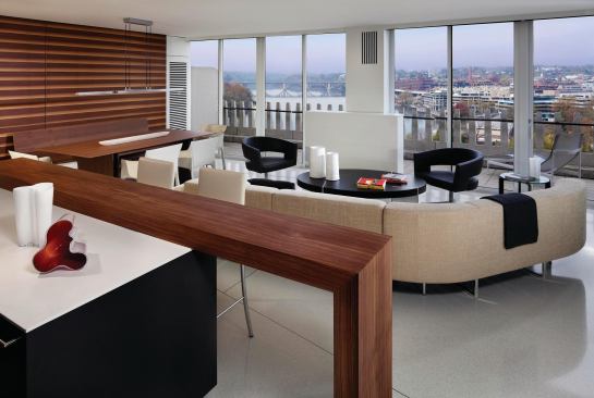 White terrazzo floors and a ribbed-grain walnut wall help the spaces flow visually.