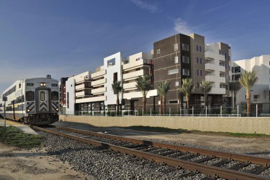 The inward-focused apartment complex is adjacent to a stop for the Metrolink commuter rail, which links Orange County with surrounding areas including Los Angeles, Riverside, and San Bernardino counties.