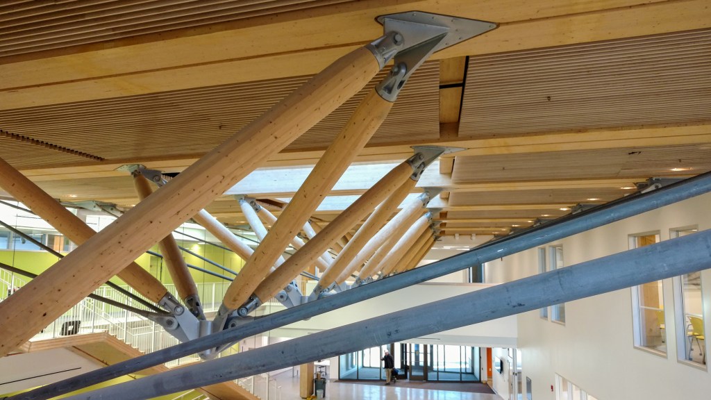 Detail of the zipper trusses, which utilize compression and tension members to transfer gravity loads to the timber structural system.