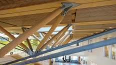 Detail of the zipper trusses, which utilize compression and tension members to transfer gravity loads to the timber structural system.